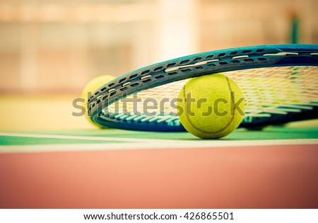 Tennis Ball with Racket on the clay tennis court