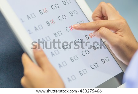 student testing in exercise, exams answer on a tablet with multiple-choice questions by finger clicking