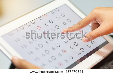 student testing in exercise, exams answer on a tablet with multiple-choice questions of e-learning by finger clicking : education concept