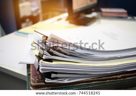 Unfinished documents stacks of paper files on office desk for report papers,piles of unfinished papers sheet achieves with clips indoor, Business offices concept.Document is  written, drawn,presented.