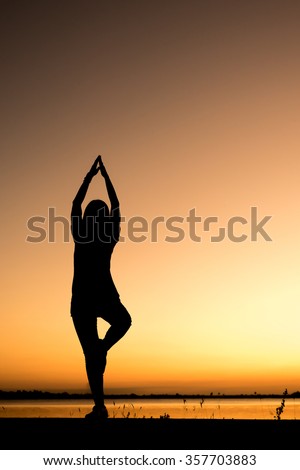 Silhouette picture show Yoga girl on sunset.