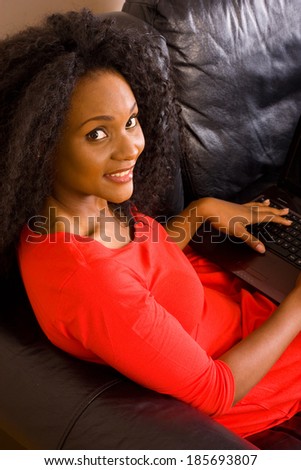 young african american woman at home with a computer.