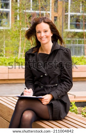 business woman with clipboard and pen.