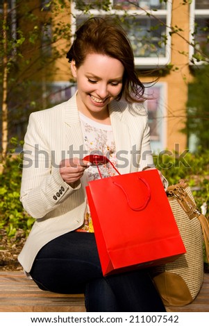 young woman reading name tag on a gift bag