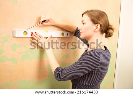 young woman using a spirit level.