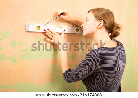 young woman using a spirit level.