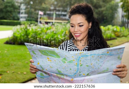 young woman reading a map.