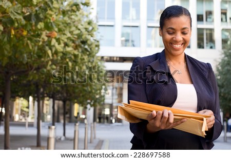 business woman holding envelopes.