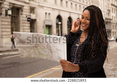 woman asking for directions on the phone with a map.