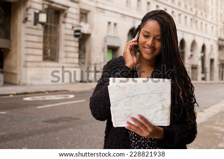 young woman on the phone with a map.