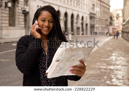 young woman on the phone holding a map