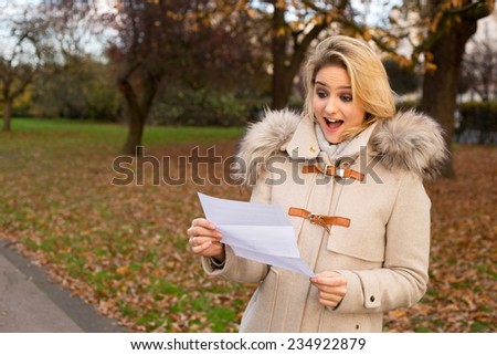 surprised woman reading a letter