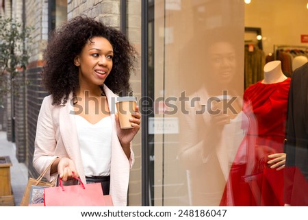 young woman with shopping bags and a coffee