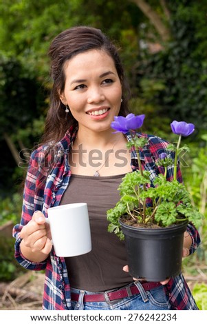 young woman enjoying a coffee while gardening