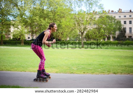young woman roller skates in the park