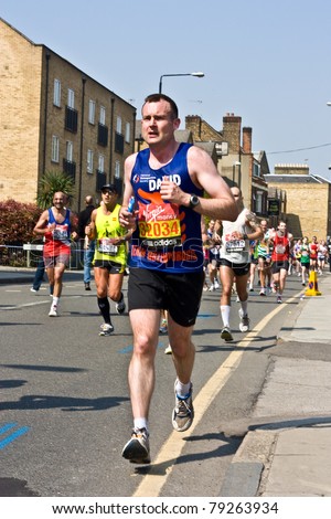 LONDON - APRIL 17: Unidentified men run the London marathon on April 17, 2011 in London, England, UK. The marathon is an annual event.