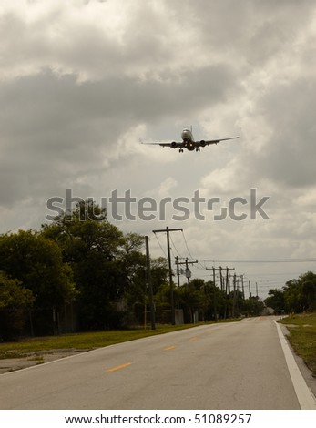 airplane take off with a cloudy sky background over a road