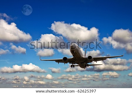 plane landing with blue sky, clouds and the moon