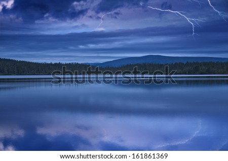 Landscape with a night thunder-storm on the lake in national park Sarek in Sweden.