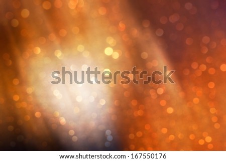 Sparkling festive background from a set of out-of-focus patches of light of warm colors.