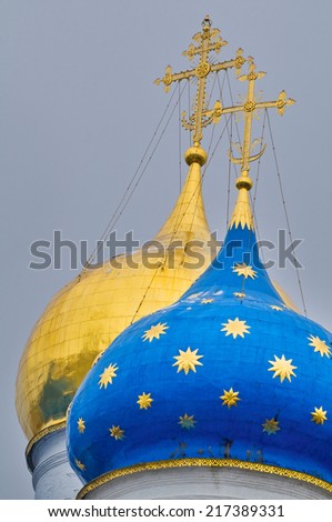 Two domes of church in Sergiev Posad in Russia. Gold dome and blue with gold stars.