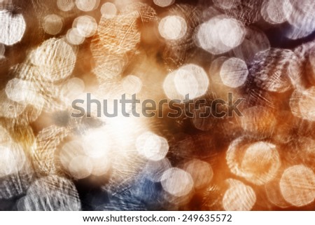 Abstract sparkling background of warm pastel colors. Out-of-focus sparkling patches of light scattered on all background.