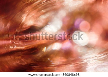 Abstract shining background. Fiery storm, patches of light and light waves against a dark background.