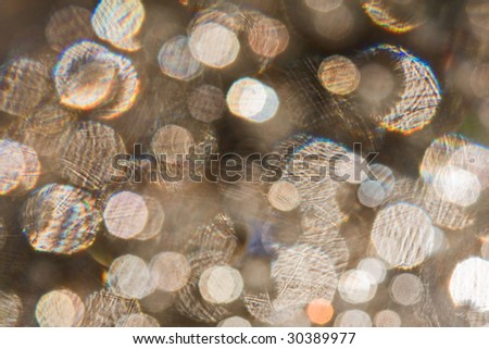 The sparkle texture. Many lens flare against a brown background.