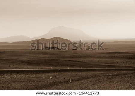Highway through Iceland Mountains landscape. Horizontal Sepia toned shot