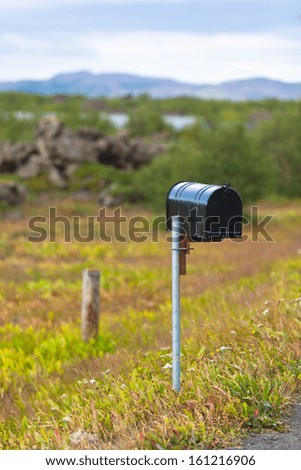 Old Weathered Mailbox at Rural Roadside in Iceland. Vertical shot
