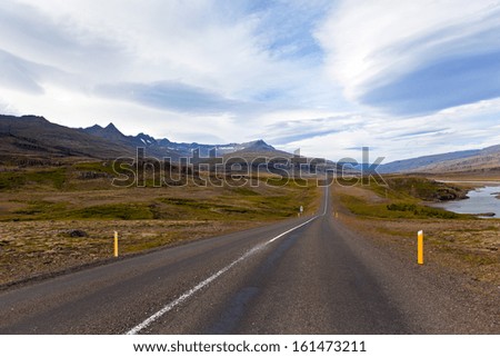 Highway through Iceland landscape at overcast day. Horizontal shot