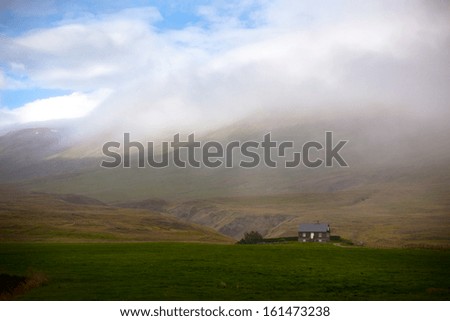 Icelandic Landscape: Lonely House in Foggy Mountains. Horizontal shot