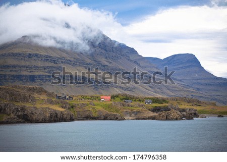 Icelandic Landscape: Houses in Foggy Mountains. Horizontal shot