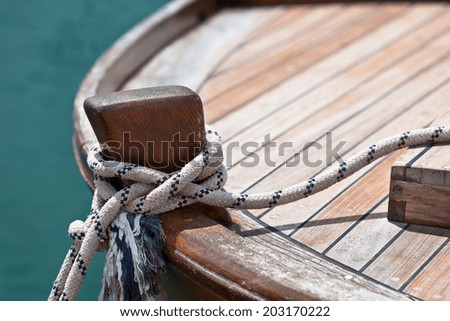 Rope on a wooden boat deck. Horizontal shot with copy space