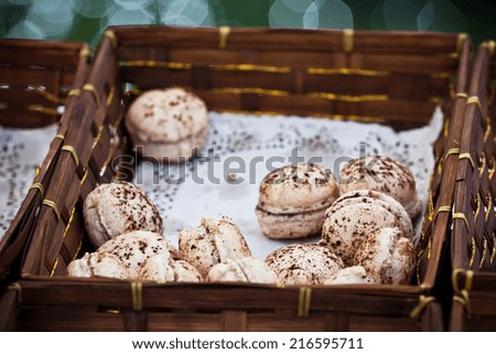 Macarons assortment in a wickered box. Horizontal shot with selective focus
