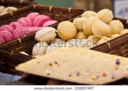 Macarons assortment in a wickered box. Horizontal shot with selective focus