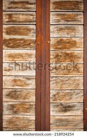 Wooden planks surface with rusty metal bands background. Vertical shot