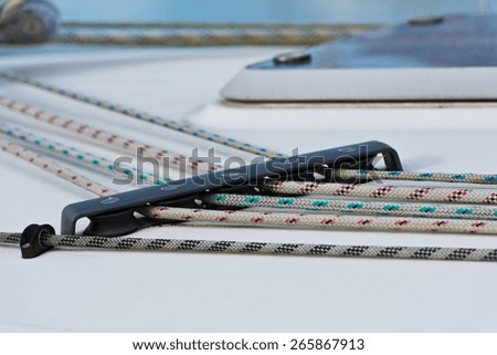 Details of sailing boat. Color ropes on white deck