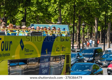 FRANCE, PARIS - JUNE 06: Tourists enjoy sightseeing tour on a hop-on-hop-off city bus in Paris on June 06, 2015.