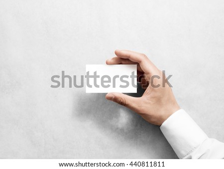 Hand holding blank white business card design mockup. Clear calling card mock up template holding arm. Visit pasteboard paper surface display front. Standart offset card print. Business card branding