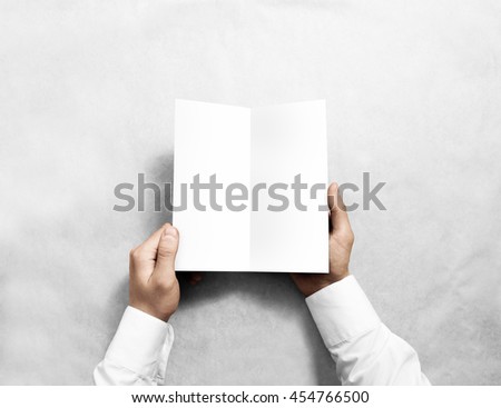 Hand opening blank white flyer brochure booklet mockup. Leaflet presentation. Pamphlet mock up holding hand. Man show clear offset paper. Booklet design template. Paper sheet display read first person