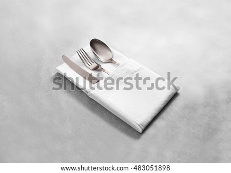 Blank white restaurant cloth napkin mock up with silver cutlery set, isolated. Knife fork and spoon in clear textile towel mockup template. Cafe branding identity clean napkin surface for logo design.