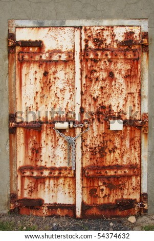 Old rusted doors chained and padlocked shut