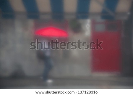 a girl walks in the rain, photo through the curtain