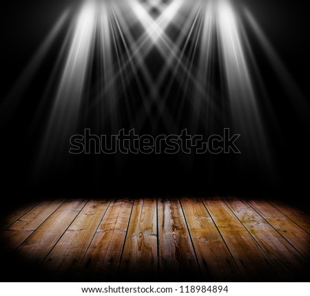 Two spot light on a wooden floor and a black background