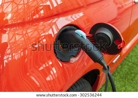 Electric red car in a charging station