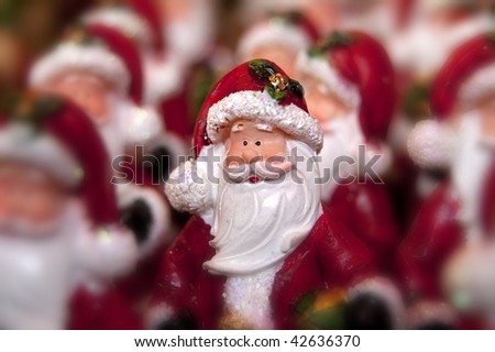 Many little statue of santa clause and one in focus
