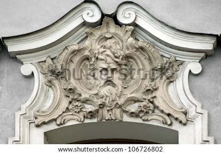 Building relief detail of architectural frieze with human head
