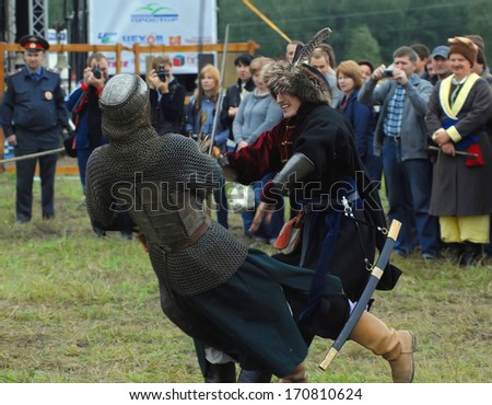 RUSSIA, MOLODI VILLAGE - JULY 27: Unidentified people fights by the swords  on event dedicated to Victory in battle near the Molodi village 1572, on July 27, 2013, in Moscow region, Russia
