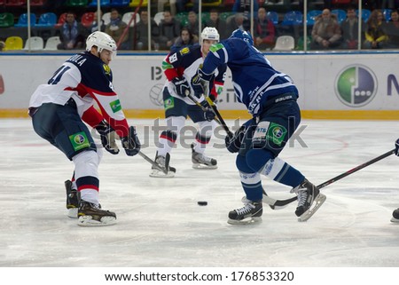 MOSCOW - JANUARY 28, 2014: M.Scoula (41) vs D.Vishnevskiy (55) in action during the KHL hockey match Dynamo Moscow vs Slovan Bratislava in sport palace Luzhniki in Moscow, Russia. Final score 2:3